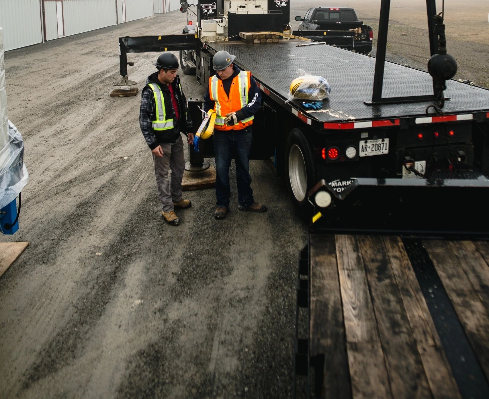 boom truck rental with operator setting up rigging for crane lift